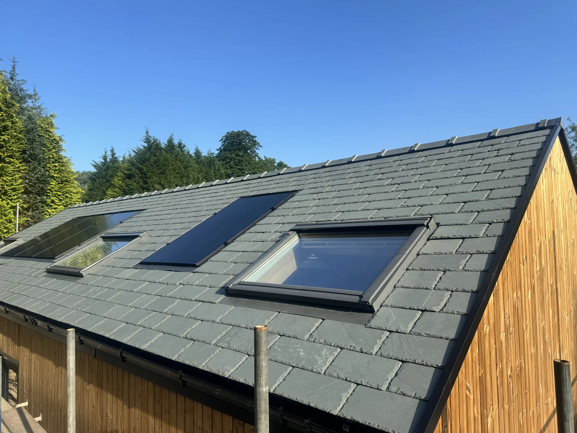 Copper dormers set cleanly into the natural slate roof