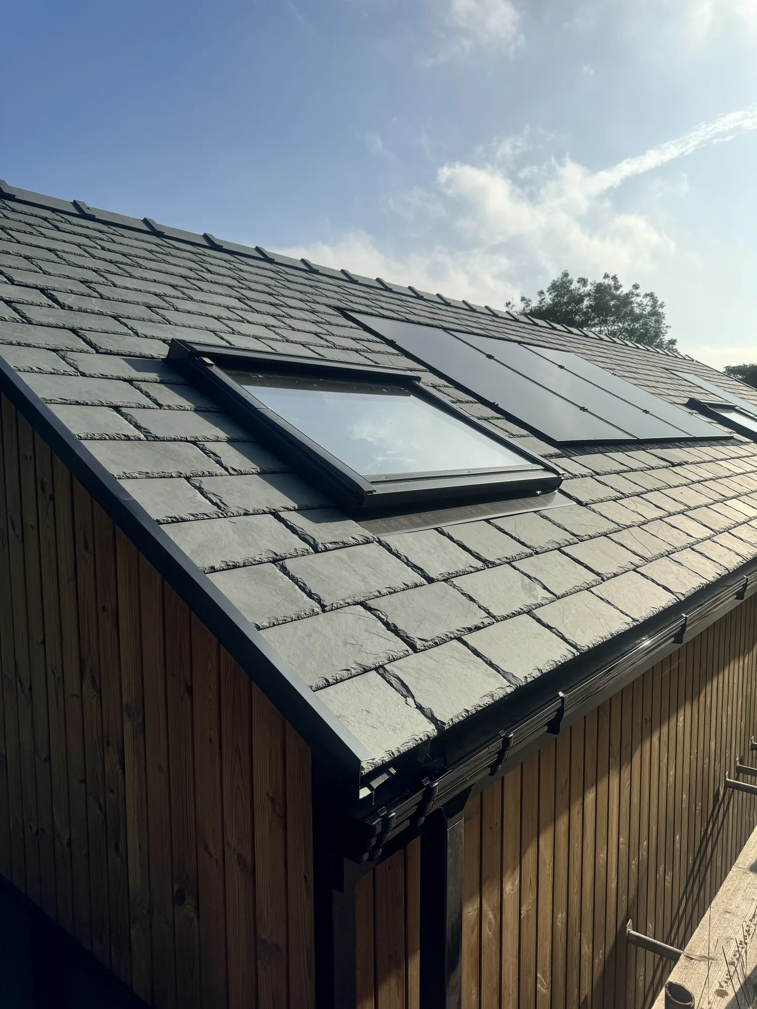Integrated solar set within the natural slate roof covering