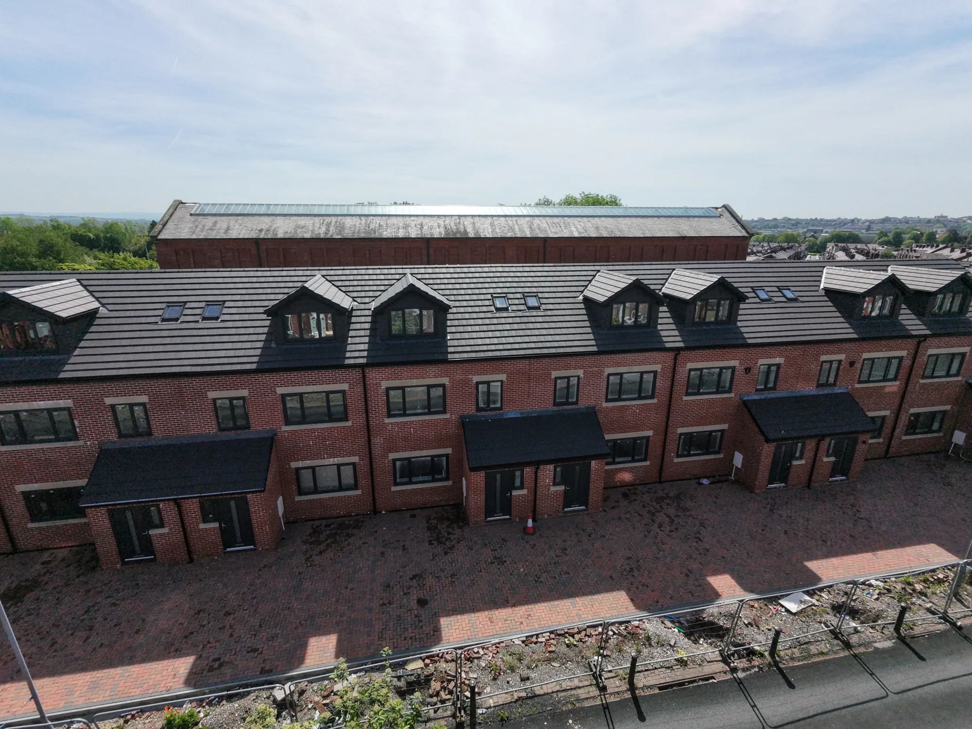 Elevated view of a terrace with new tiled roofs and dormers