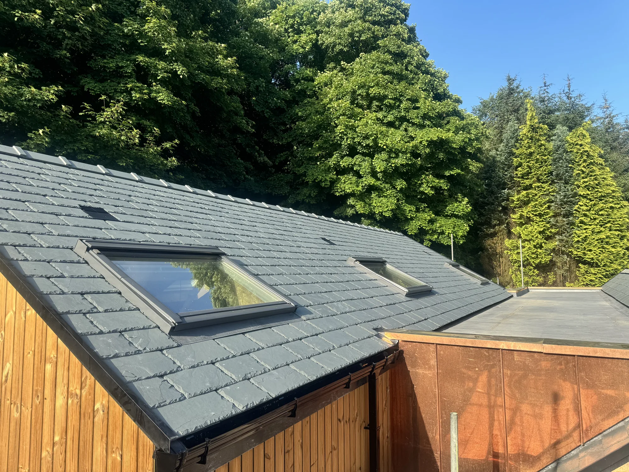 Completed natural slate re-roof with new roof windows