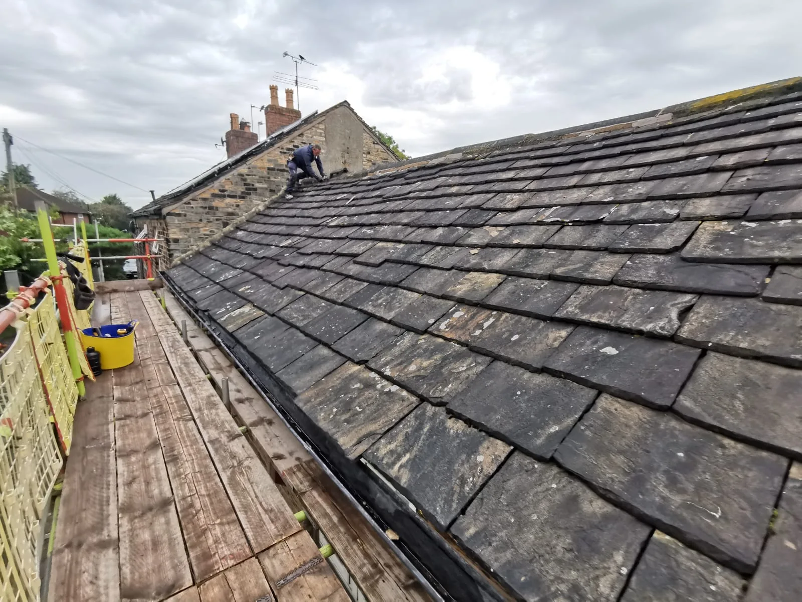 Stone slate re-roof in progress on a character property